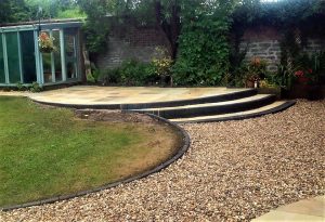 custom garden with raised paved area and stones